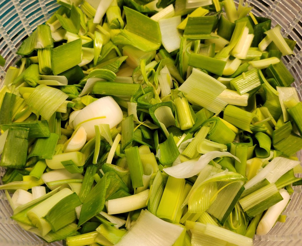 chopped leeks in collander for washing